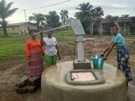 Women collecting water from a community hand pump